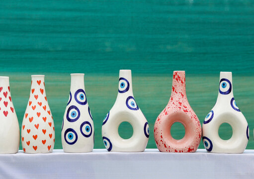 A Collection of flower Vases painted in vibrant colors, porcelain, China, handmade, clay art, pottery, design, pattern, culture of India.