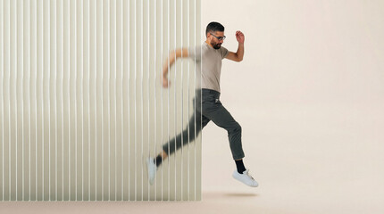 Man in motion breaking through 3D fluted glass barrier