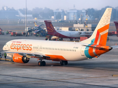 Air India express country's flagship carrier being inspected on the tarmac waiting for flight in foggy conditions