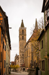 Gothic church tower on medieval street in Rothenburg ob der Tauber old town