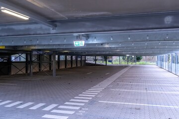 Fototapeta premium Empty parking garage with visible exit sign