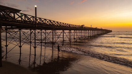 Summer sunset at the port of Pimentel, with a view of the pier in Chiclayo, Lambayeque, on the Peruvian coast