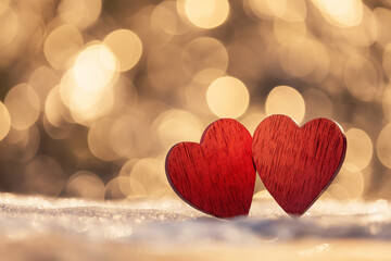 Fototapeta premium Symbol of love with red hearts and warm light bokeh
