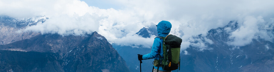 Backpacking woman hiking on high altitude mountain top