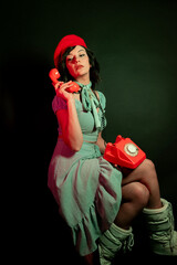 Young Woman Talking on a Retro Phone in a Neon-Lighted Studio Environment - Communication Concep