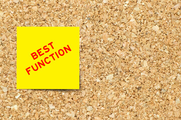 Yellow note paper with word best function on cork board background with copy space