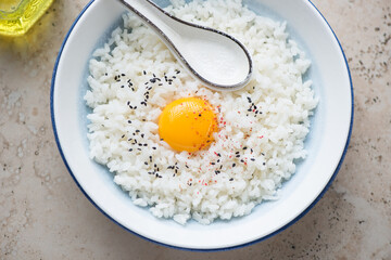 Japanese tamago kake gohan or warm rice mixed with a raw chicken egg, horizontal shot, middle closeup