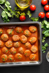 Meatballs with tomato sauce in baking dish