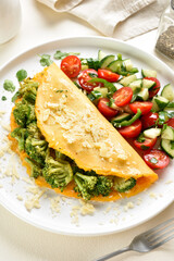 Omelet with roasted broccoli and cheese served with salad from f