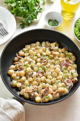 Potato gnocchi with bacon in pan