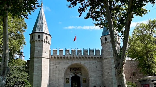 Istanbul, Turkey, August 1, 2025. The entrance to Topkapi Palace on a beautiful summer's day, with the heads of visitors queuing to enter and visit. Travel destinations.