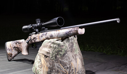 Bolt action rifle at a dark outdoor range