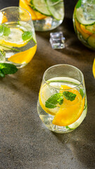 Refreshing citrus beverage with mint leaves and ice cubes in stylish glassware