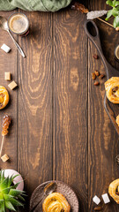 Delicious pastries and coffee arranged on rustic wooden table with copy space for design