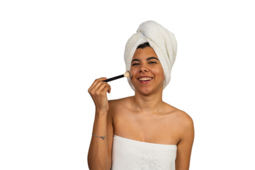 Young woman applying makeup looking at camera