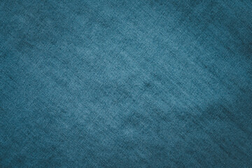 Blue denim fabric texture background with subtle textile pattern provides clean minimal surface for design use branding presentation advertising fashion concept and modern copy space.