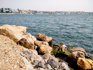 Cascais, Portugal. Rocks against the backdrop of the city from the ocean.