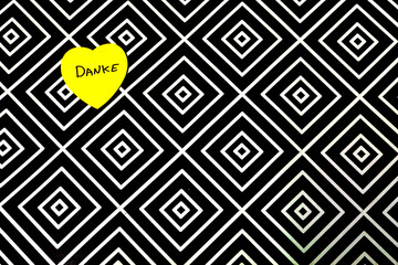 A black and white patterned background with a yellow heart