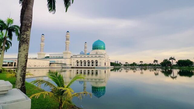 Malaysia - 31.06.2025: Bandaraya City Mosque on the shores of Likas Bay in Kota Kinabalu, Sabah. A beautiful floating mosque in Southeast Asia during the summer, with a reflection in the water. 4К