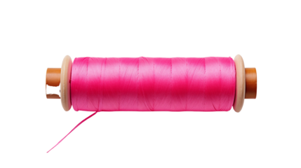 Vibrant pink thread spool on wooden bobbin against black background