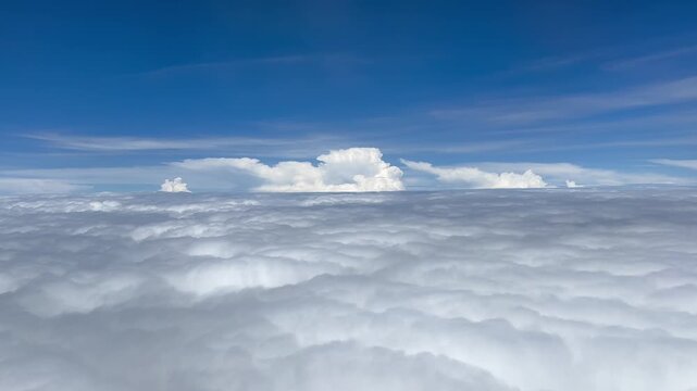 Aerial View of Cloudy Sky from Airplane Window