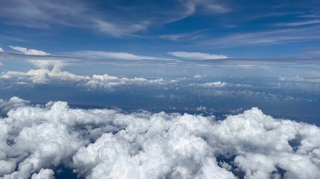 Aerial View of Cloudy Sky from Airplane Window