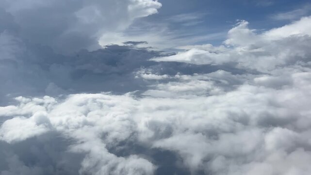 Aerial View of Cloudy Sky from Airplane Window