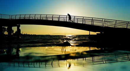 Sunset Reflection Under A Bridge