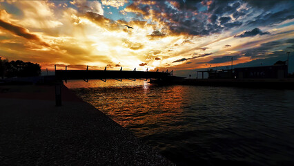 Sunset Over Pier And Calm Sea