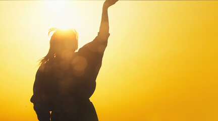 Woman Reaching Up At Sunset Silhouette at Sunset