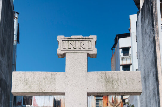macao stone cross with inri inscribed on it