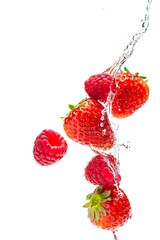 Fresh Strawberries and Raspberries Splashing in Clear Water Flow on White Background