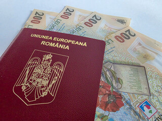 Romanian European Union biometric passport with boarding pass against a white background with Romanian Lei cash money
