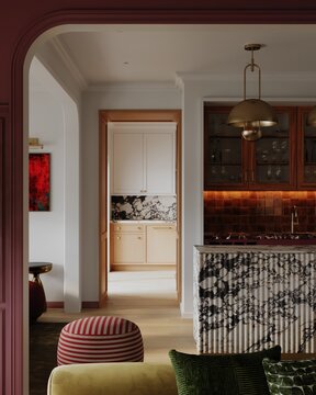 Stylish open-plan interior with an arched doorway, textured surfaces, and warm lighting connecting living and kitchen spaces.