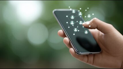 A hand is holding a cell phone with a network of people on the screen. Concept of social media and the interconnectedness of people in the digital age - Powered by Adobe