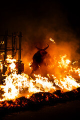 Krampus in the midst of flames is a demonic being that accompanies the religious folkloric figure. This tradition is linked to Christian mythology.