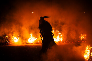 Krampus in the midst of flames is a demonic being that accompanies the religious folkloric figure. This tradition is linked to Christian mythology.