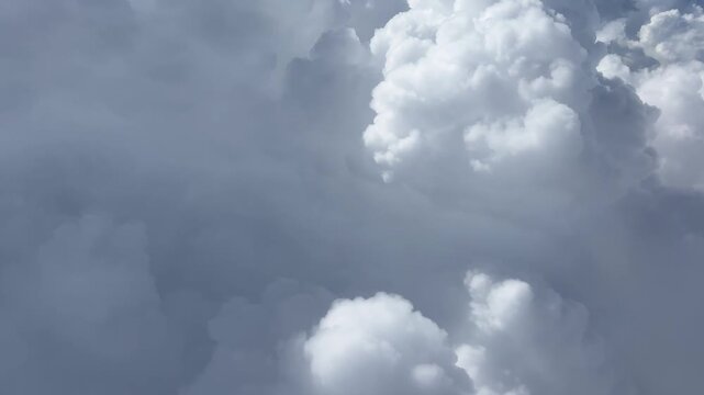 Aerial View of Cloudy Sky from Airplane Window