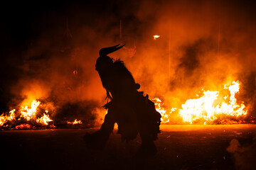 Krampus in the midst of flames is a demonic being that accompanies the religious folkloric figure. This tradition is linked to Christian mythology.
