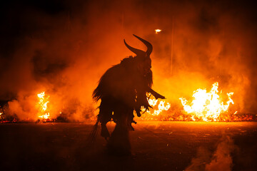 Krampus in the midst of flames is a demonic being that accompanies the religious folkloric figure. This tradition is linked to Christian mythology.