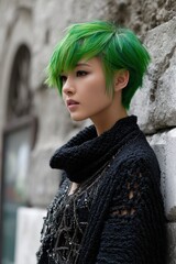 A woman with green hair is standing in front of a wall