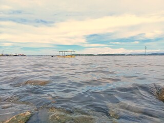 Minimal seascape with yellow boat