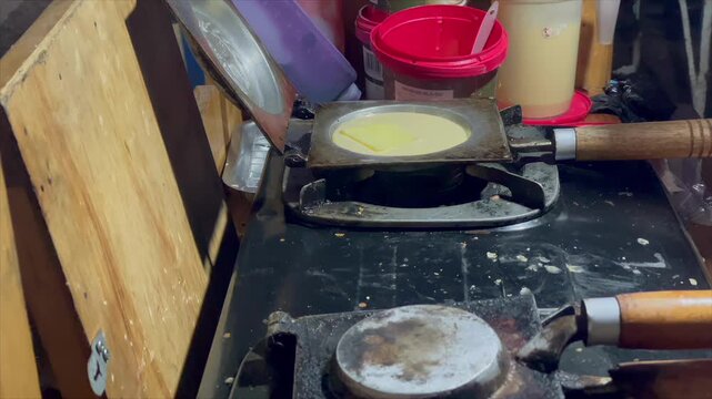 Video cooking hotteok (korean pancake) with melted mozzarella cheese topping on a pan
