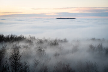 Aerial view of Cmelok hill in the Little Carpathians, Slovakia, appearing as a forest island above...