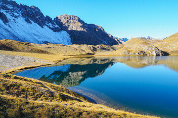 Naklejka premium Wild Lechtal Alps with rugged peaks and a tranquil alpine mountain lake.