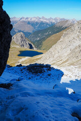 Wild Lechtal Alps with rugged peaks and a tranquil alpine mountain lake.