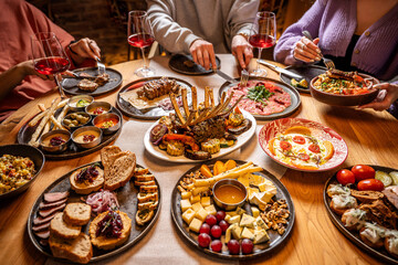 Shared restaurant table with gourmet dishes and wine