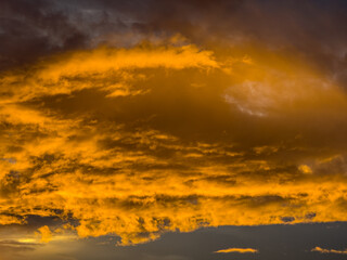 Beautiful sky view at sunset or sunrise with orange clouds and blue sky background. Sky landscape at dusk.