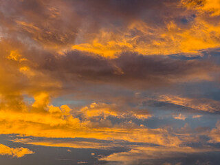Beautiful sky view at sunset or sunrise with orange clouds and blue sky background. Sky landscape at dusk.