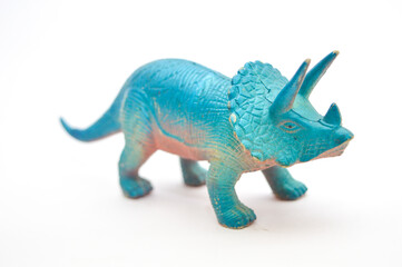 Blue Triceratops dinosaur toy figurine isolated on white background. Detailed plastic prehistoric animal model for kids education, play, and creative design concepts. © Setyotuhu